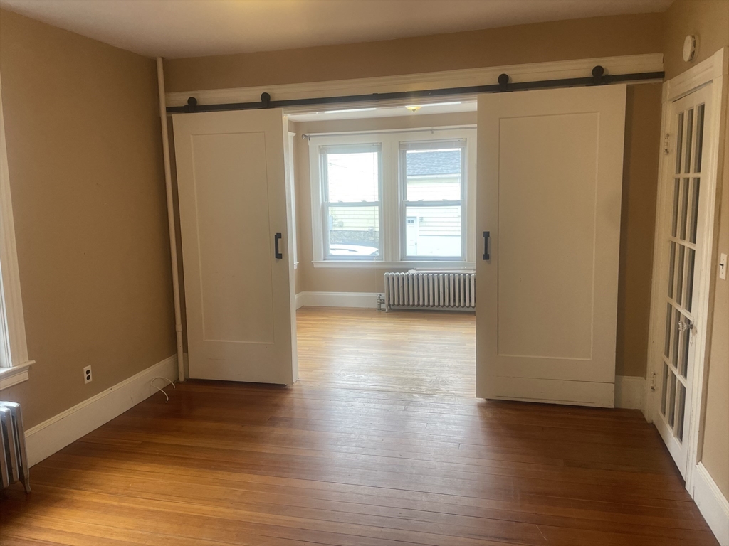 44 Sculpin Way, Unit 44 Swampscott, MA 01907 - Photo 6 of 21 a view of empty room with wooden floor and fan