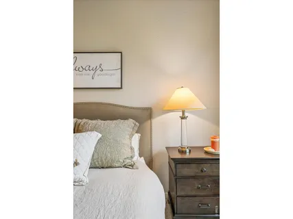a bedroom with a bed and a lamp