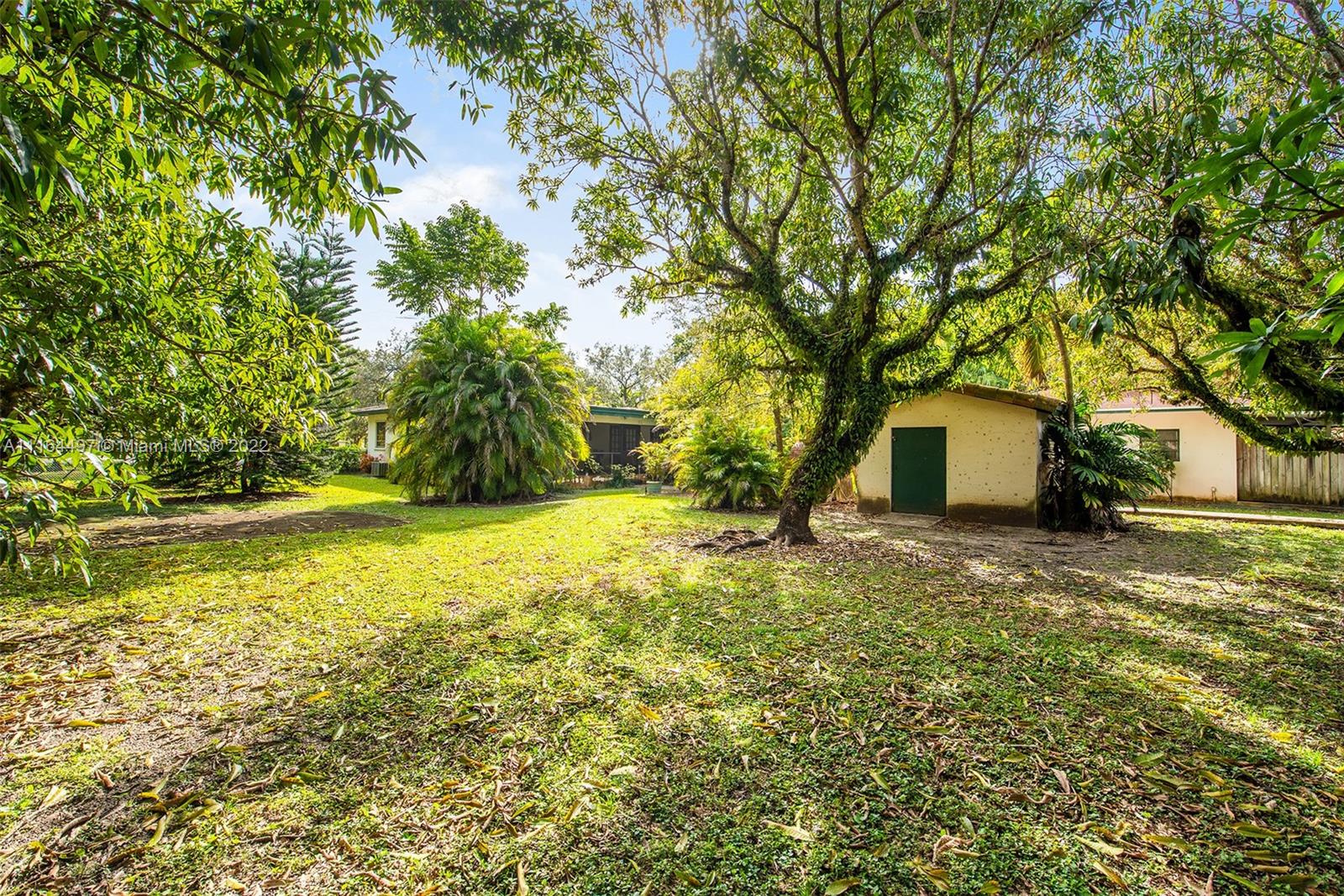 7335 Southwest 104th Street Pinecrest, FL 33156 - Photo 12 of 16 a view of a house with a yard