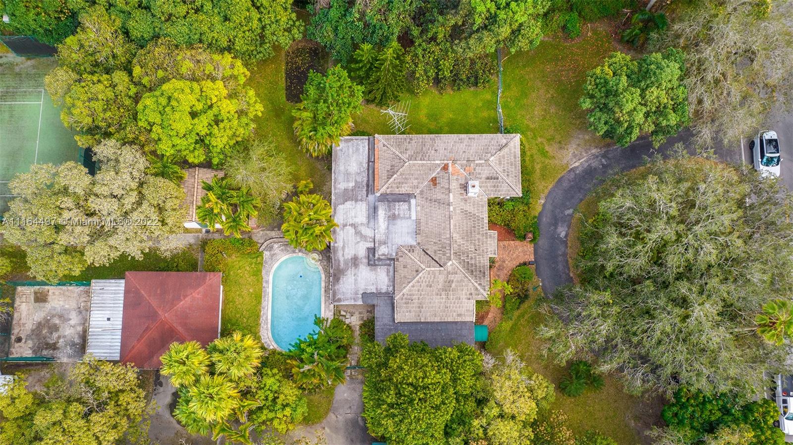 7335 Southwest 104th Street Pinecrest, FL 33156 - Photo 5 of 16 an aerial view of a house with a yard and garden