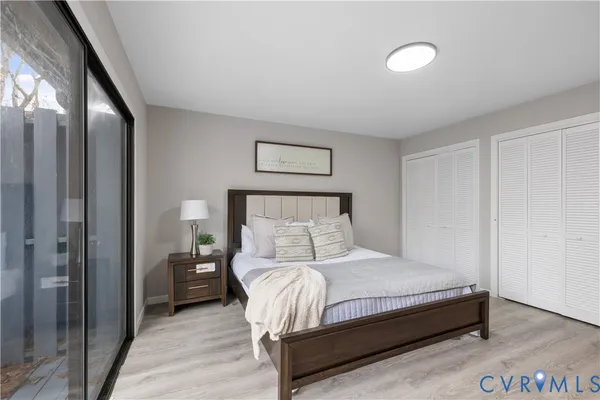 a bedroom with a bed and a night stand