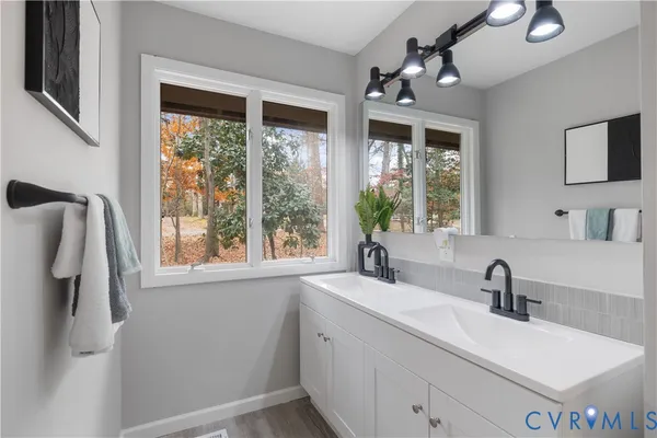 a bathroom with a sink and a window