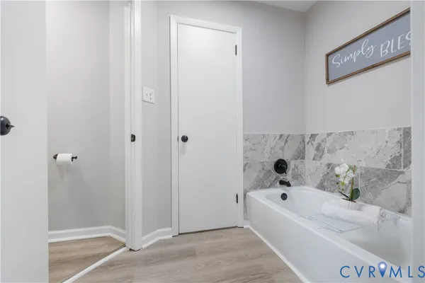a bathroom with a bathtub and shower