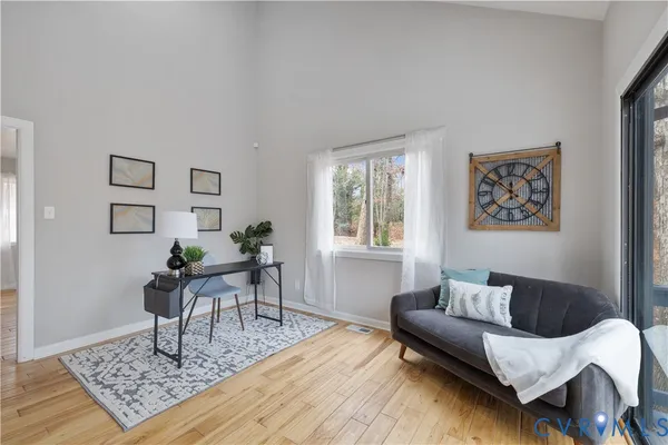 a living room with furniture and wooden floor