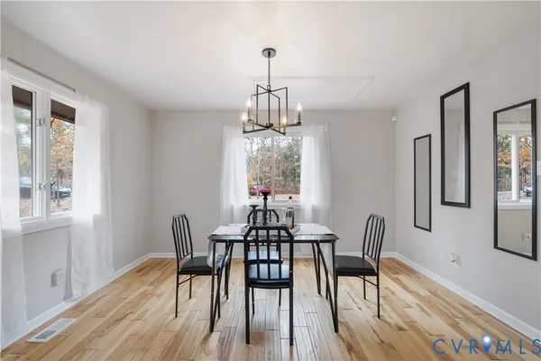 a view of a dining room with furniture window and wooden floor