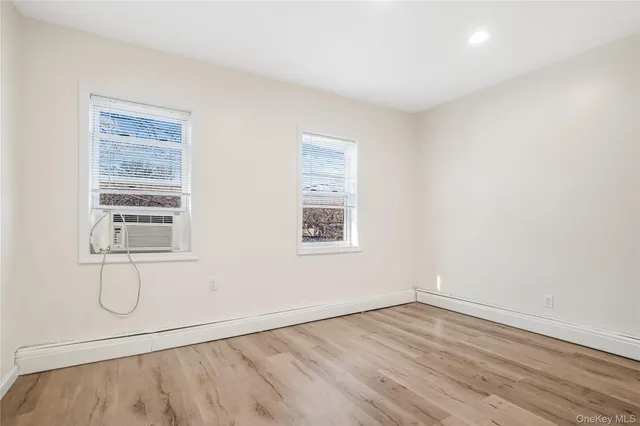 an empty room with a empty space and windows