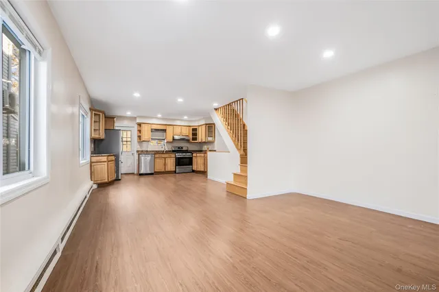 a view of kitchen with refrigerator and window