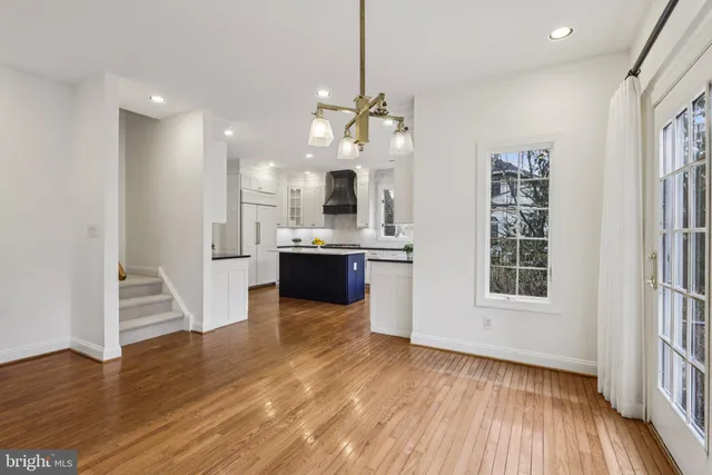 a kitchen with granite countertop a sink a counter space appliances and cabinets