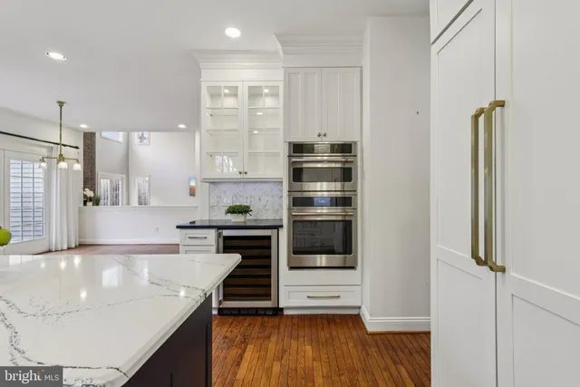 a view of a room with wooden floor and windows