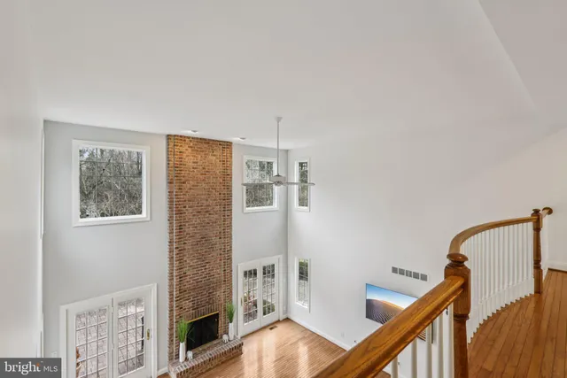 a view of an empty room with a window and fire place