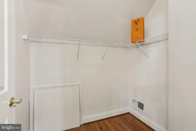 a view of a white house with large windows next to a yard