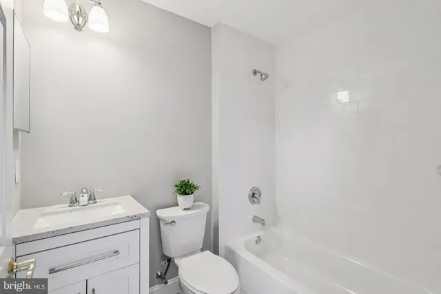 an aerial view of a house with a yard and mountain view in back