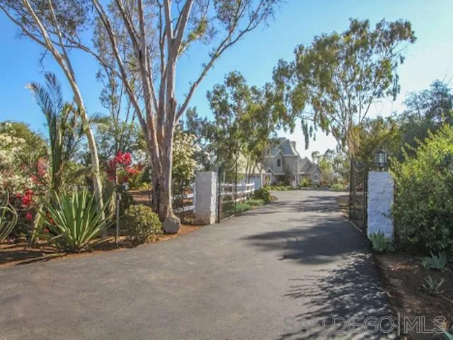 16544 Franzen Farm Road San Diego, CA 92127 - Photo 1 of 25 a row of palm trees in front of a house