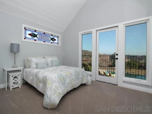 16544 Franzen Farm Road San Diego, CA 92127 - Photo 11 of 25 a bedroom with a bed and a large window