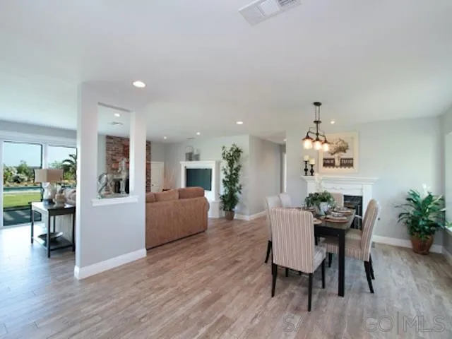16544 Franzen Farm Road San Diego, CA 92127 - Photo 16 of 25 a dining room with furniture and wooden floor