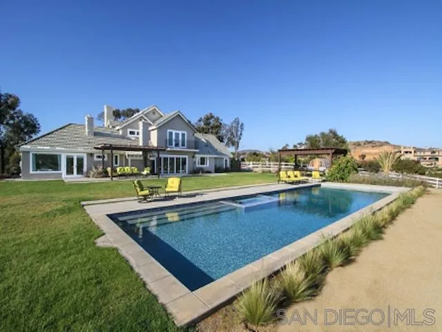 16544 Franzen Farm Road San Diego, CA 92127 - Photo 2 of 25 a view of a house with pool and a yard