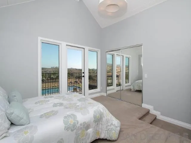 16544 Franzen Farm Road San Diego, CA 92127 - Photo 10 of 25 a spacious bedroom with a bed and a large window