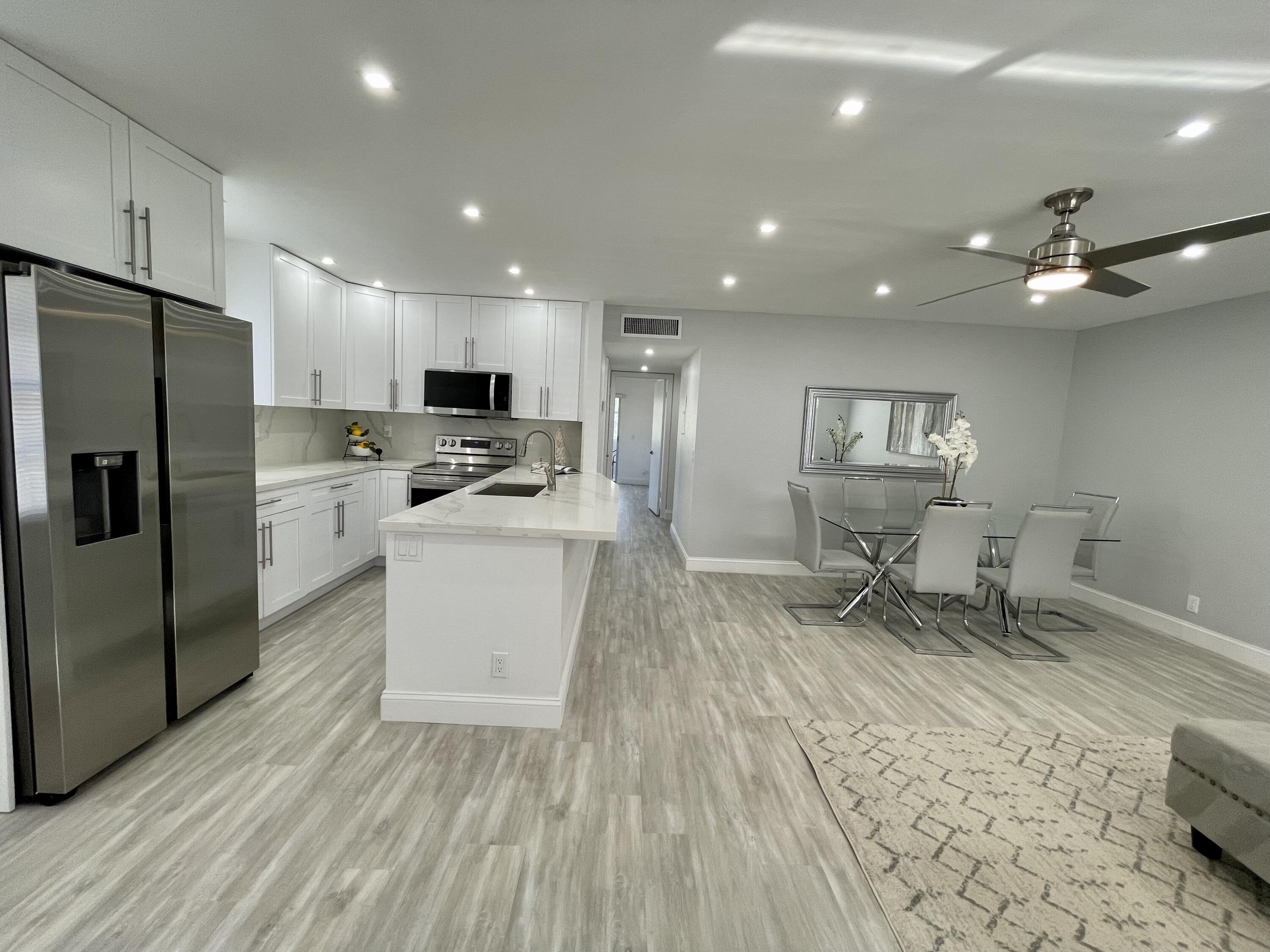 a kitchen with sink cabinets and stainless steel appliances