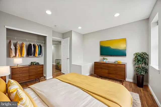 a bedroom with a bed and a flat screen television