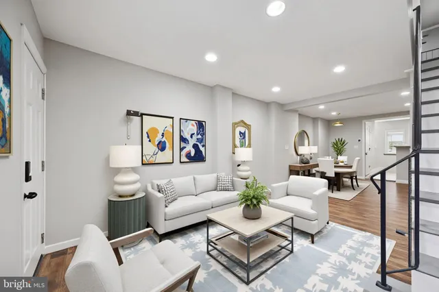 a living room with furniture and a painting on the wall