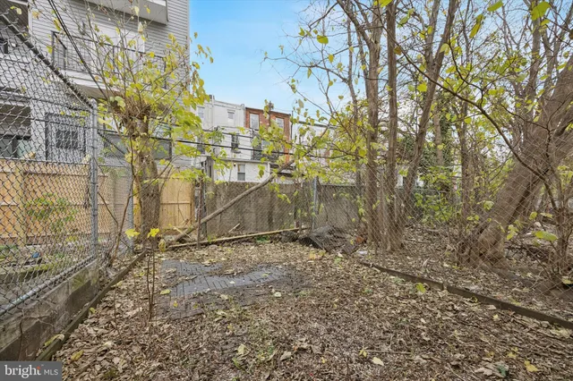 a view of empty room with wooden fence