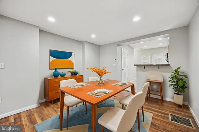 a dining room with furniture and wooden floor