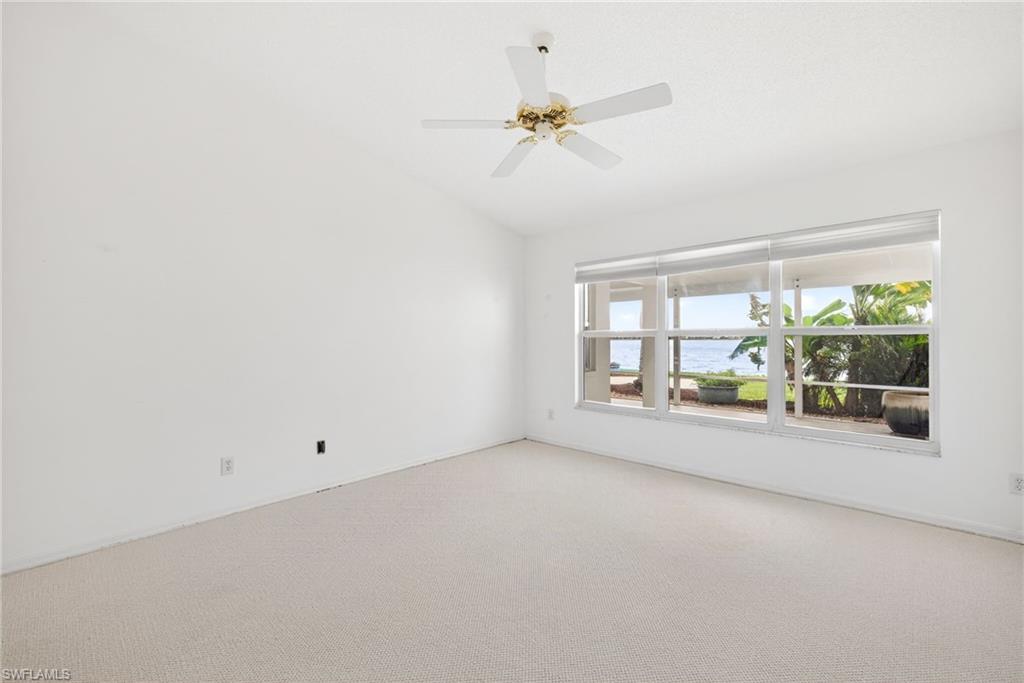7071 Mill Pond Circle Naples, FL 34109 - Photo 11 of 24 Carpeted empty room with a ceiling fan and lofted ceiling
