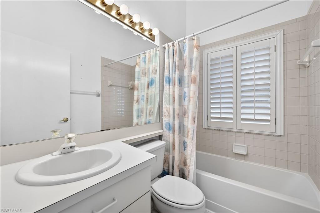 7071 Mill Pond Circle Naples, FL 34109 - Photo 15 of 24 Full bath with shower / bathtub combination with curtain and vanity
