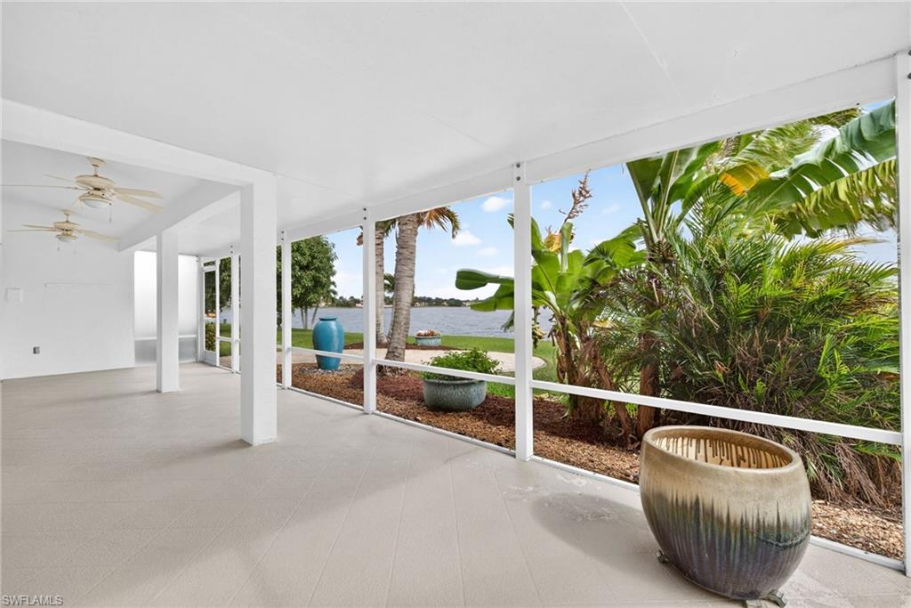 7071 Mill Pond Circle Naples, FL 34109 - Photo 19 of 24 Unfurnished sunroom featuring a water view, a patio, and ceiling fan