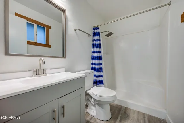 a bathroom with a sink toilet and shower