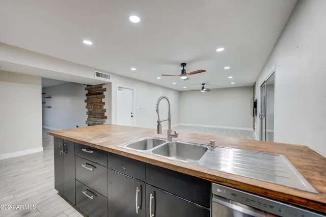 a kitchen with a sink and chandelier