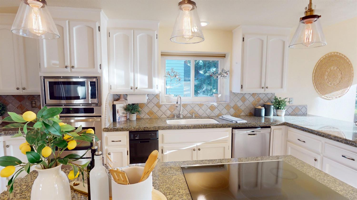 3379 Cambridge Road Cameron Park, CA 95682 - Photo 12 of 74 Window at the kitchen sink. Stainless steel appliances including microwave, dishwasher, and oven. Kitchen also features trash compactor.