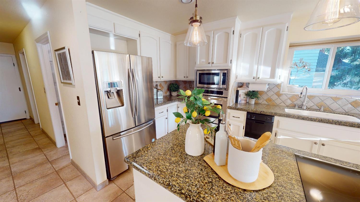3379 Cambridge Road Cameron Park, CA 95682 - Photo 13 of 74 a kitchen with a refrigerator and a table