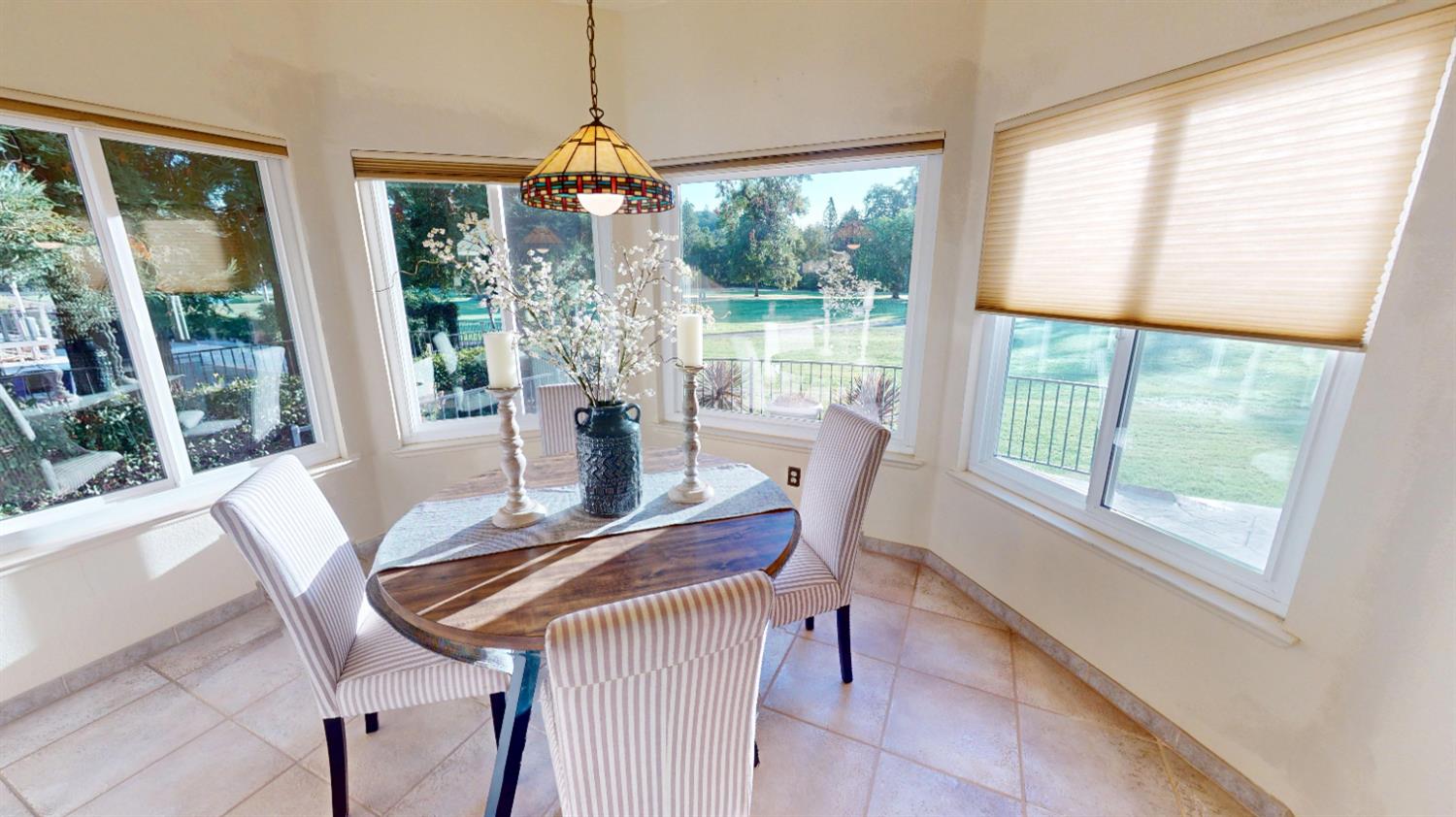 3379 Cambridge Road Cameron Park, CA 95682 - Photo 15 of 74 a view of a dining room with furniture large windows and wooden floor