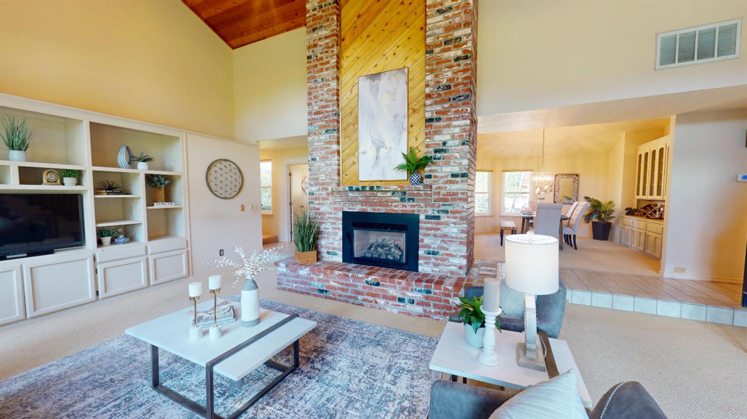 3379 Cambridge Road Cameron Park, CA 95682 - Photo 25 of 74 a living room with furniture a fireplace and a flat screen tv