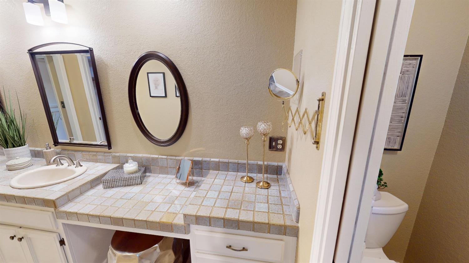 3379 Cambridge Road Cameron Park, CA 95682 - Photo 46 of 74 Primary bathroom latrine is hidden behind a partial wall with a pocket door for privacy.