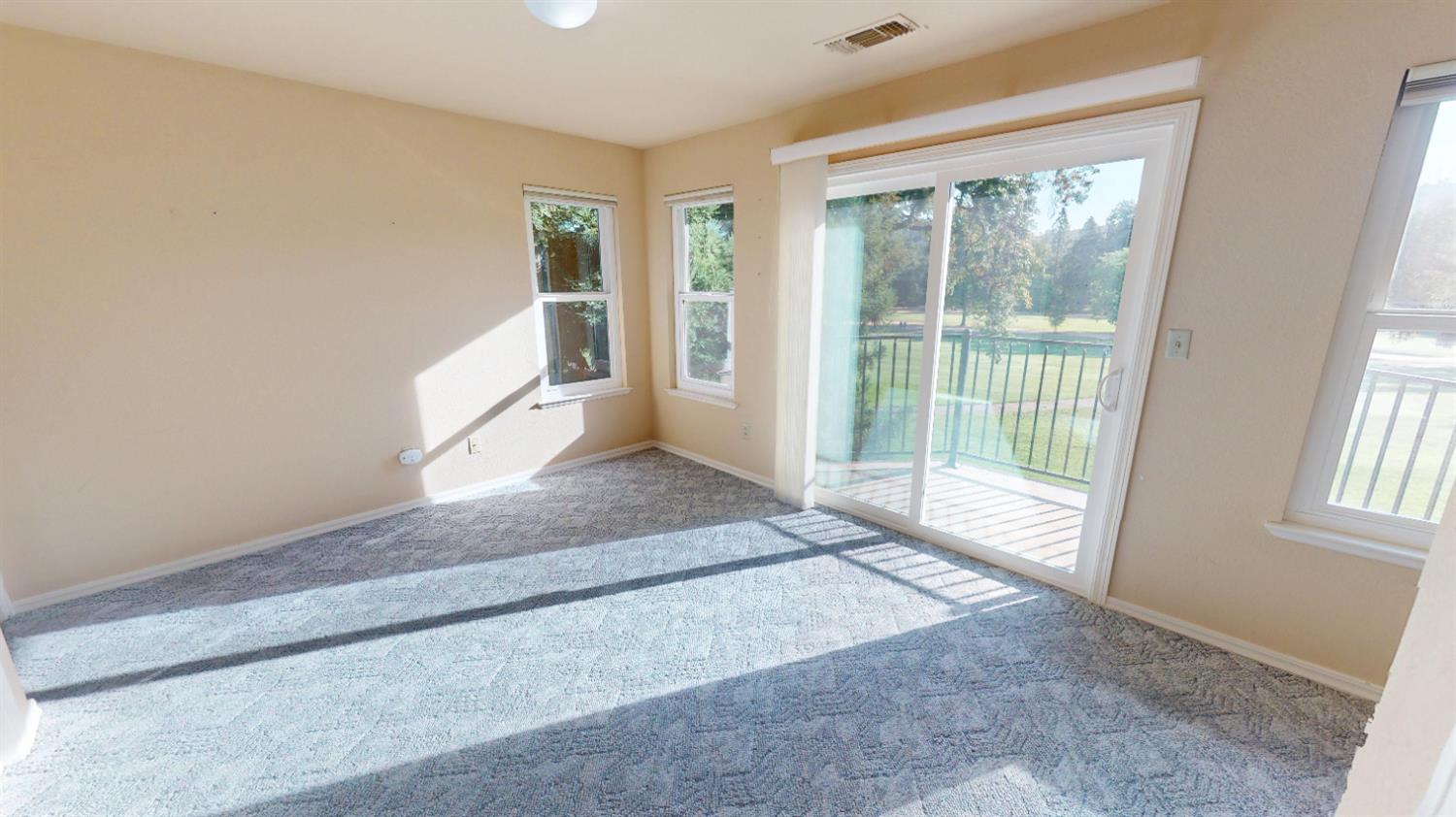 3379 Cambridge Road Cameron Park, CA 95682 - Photo 57 of 74 This bedroom features a sliding glass door that leads to a private patio overlooking the property and the golf course.