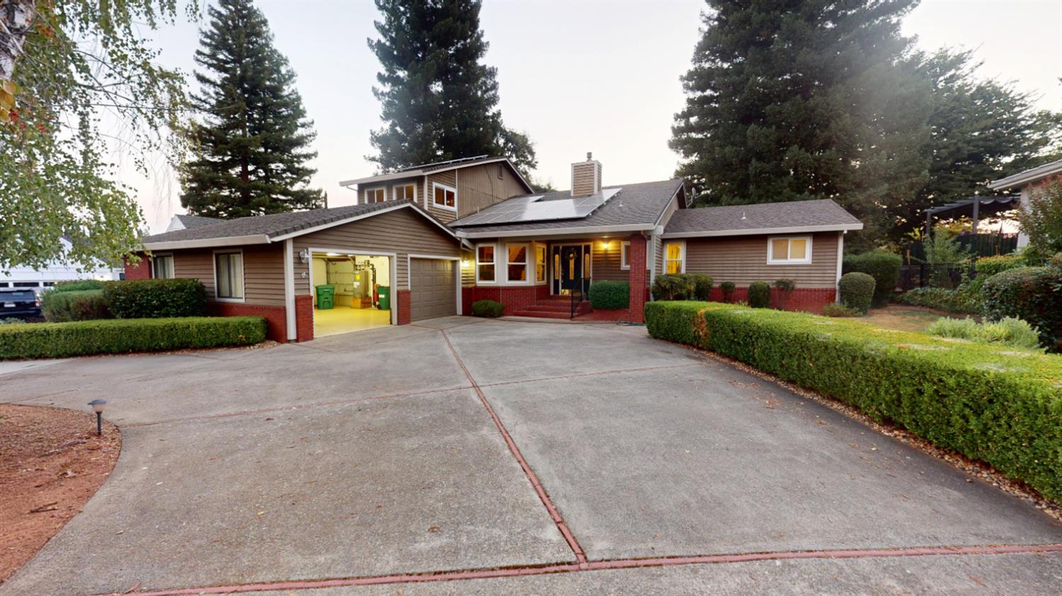 3379 Cambridge Road Cameron Park, CA 95682 - Photo 73 of 74 a front view of a house with a yard and garage