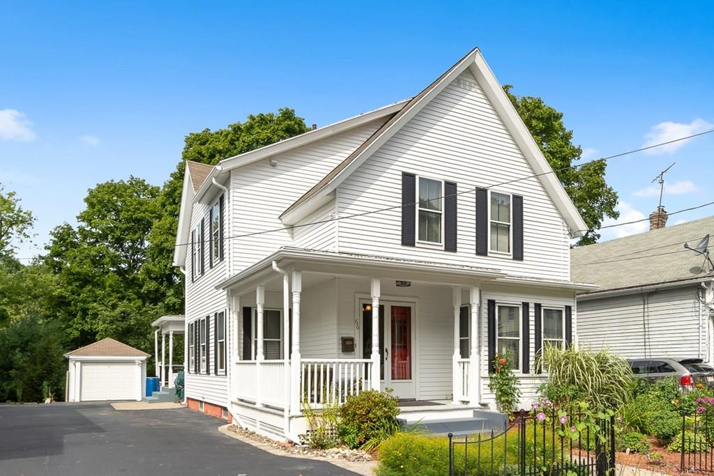 a view of a white house next to a yard