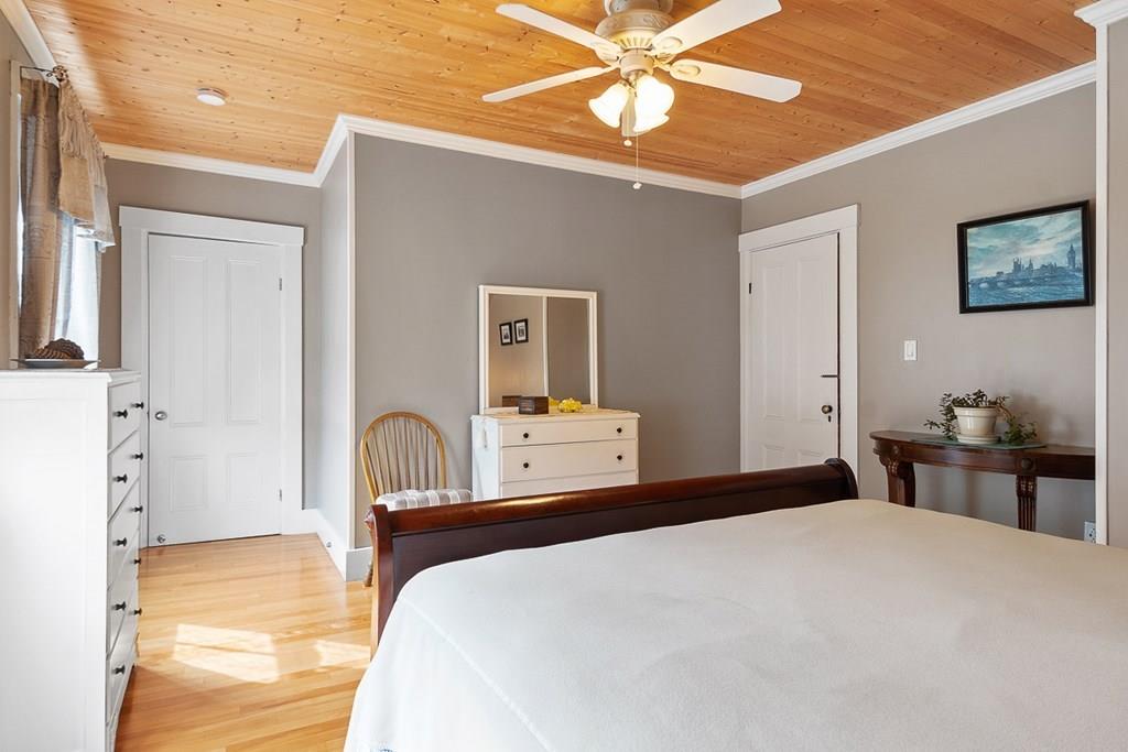 66 Manning Street Hudson, MA 01749 - Photo 19 of 40 a bedroom with a bed and a chandelier