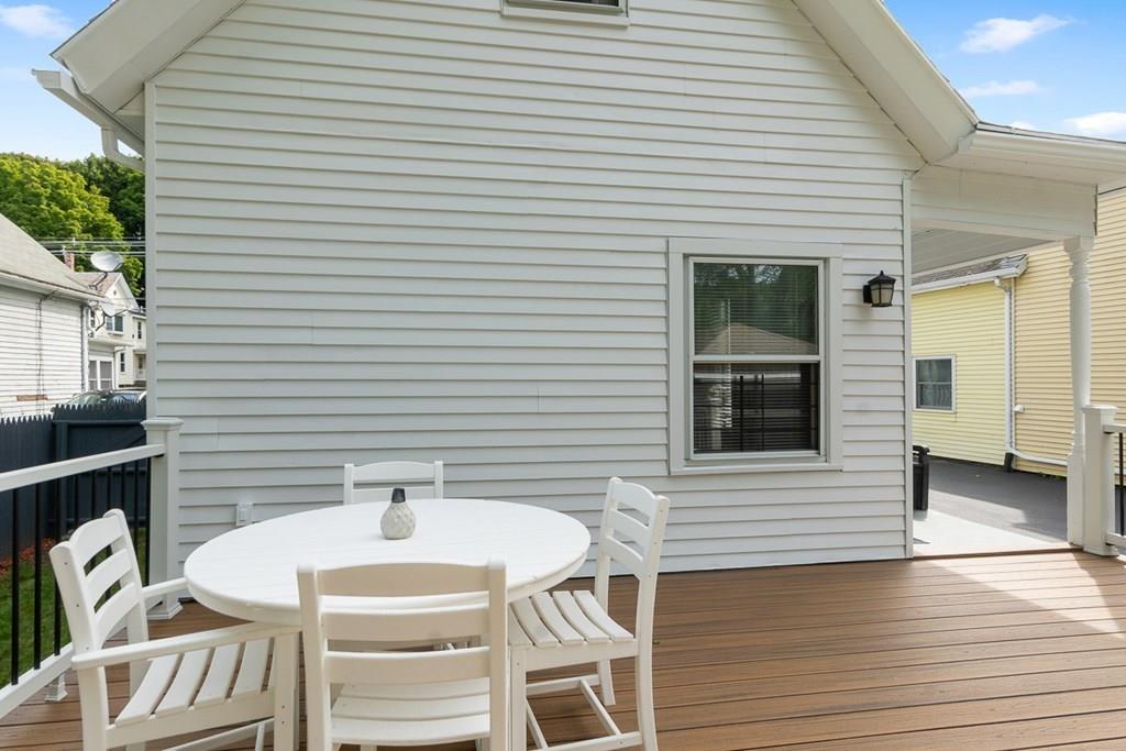 66 Manning Street Hudson, MA 01749 - Photo 29 of 40 a patio with table and chairs and wooden floor