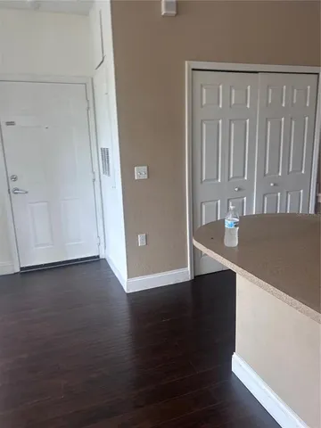a view of a room with wooden floor