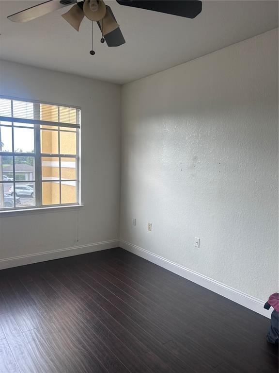 8213 Claire Ann Drive, Unit 203 Orlando, FL 32825 - Photo 8 of 9 an empty room with wooden floor and windows