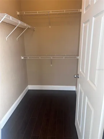 an empty room with wooden floor