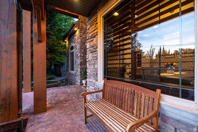 687 South 2080th Street East Springville, UT 84663 - Photo 131 of 149 Stone veneer exterior with a prominent window, stamped concrete patio, and substantial wood architectural elements