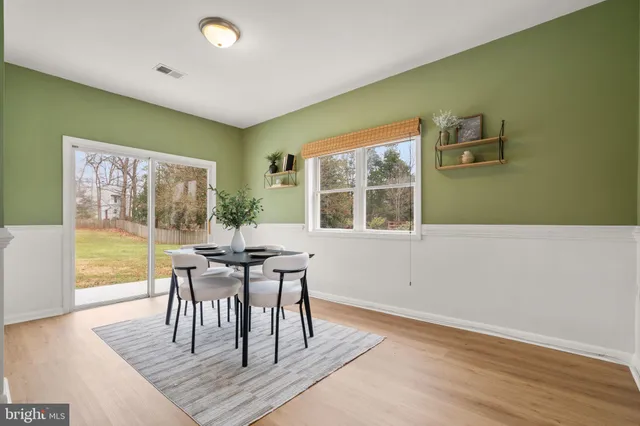 a dining room with furniture and wooden floor