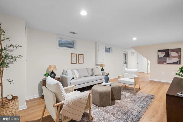 a living room with furniture or couch and a wooden floor