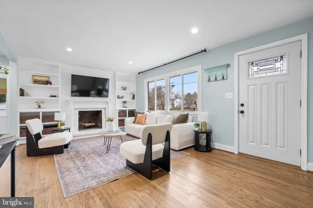 a living room with fireplace furniture and a flat screen tv