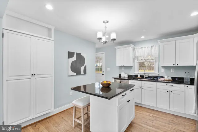 a kitchen with a sink a stove a refrigerator and cabinets