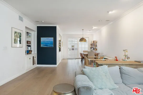 a living room with furniture and kitchen view